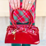 Red Vienna Crossbody Purse featuring vegan leather construction, gold-tone accents, and detachable tassel strap.