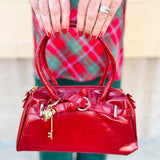 Red Vienna Crossbody Purse featuring vegan leather construction, gold-tone accents, and detachable tassel strap.