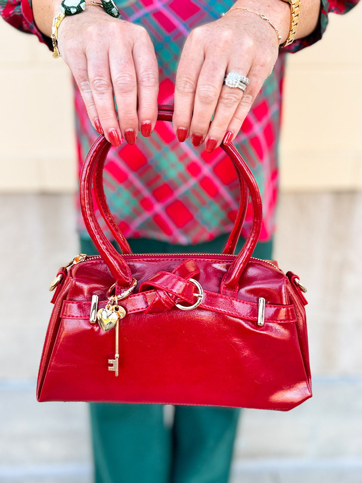Red Vienna Crossbody Purse featuring vegan leather construction, gold-tone accents, and detachable tassel strap.