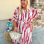 Model Crystal wearing the Red, White & Boom Dolman Sleeve Midi Dress featuring a bold zebra print, dolman sleeves, and a flattering elastic waist – styled for a confident, comfortable look perfect for day or night