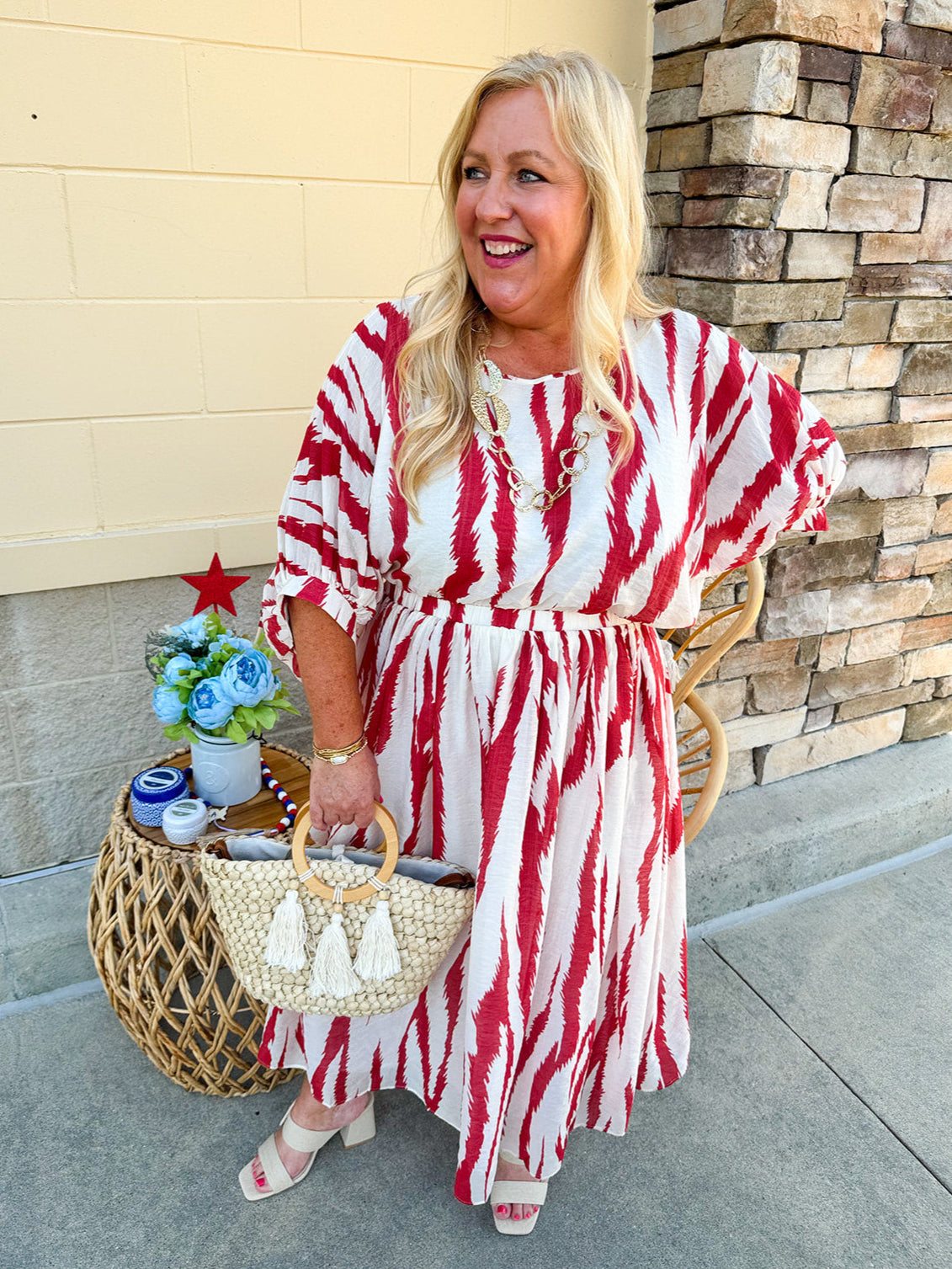 Model Crystal wearing the Red, White & Boom Dolman Sleeve Midi Dress featuring a bold zebra print, dolman sleeves, and a flattering elastic waist – styled for a confident, comfortable look perfect for day or night