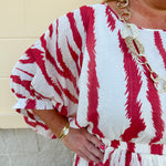 Model Crystal wearing the Red, White & Boom Dolman Sleeve Midi Dress featuring a bold zebra print, dolman sleeves, and a flattering elastic waist – styled for a confident, comfortable look perfect for day or night