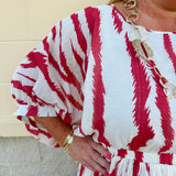 Model Crystal wearing the Red, White & Boom Dolman Sleeve Midi Dress featuring a bold zebra print, dolman sleeves, and a flattering elastic waist – styled for a confident, comfortable look perfect for day or night