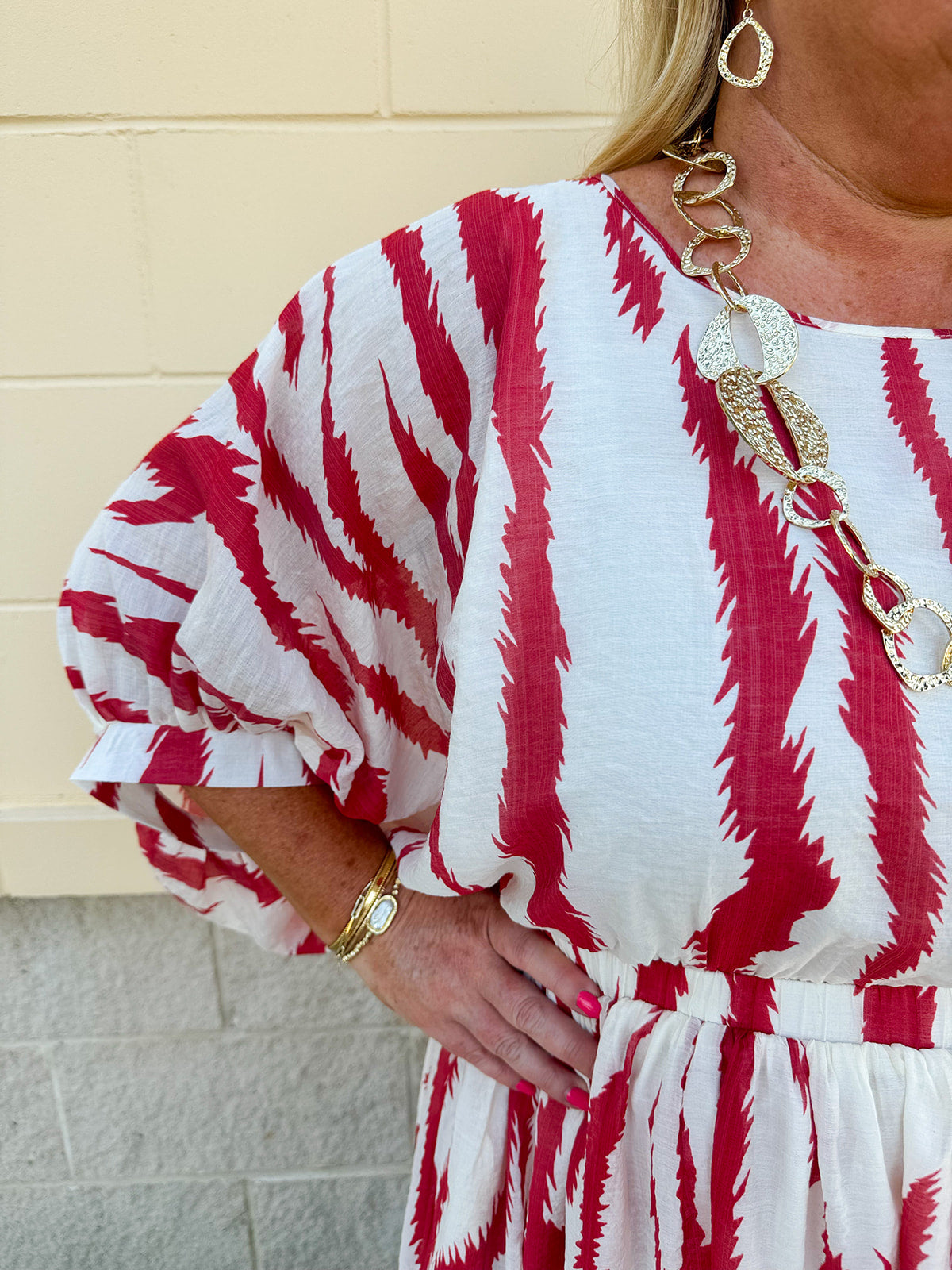 Model Crystal wearing the Red, White & Boom Dolman Sleeve Midi Dress featuring a bold zebra print, dolman sleeves, and a flattering elastic waist – styled for a confident, comfortable look perfect for day or night