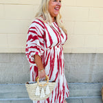 Model Crystal wearing the Red, White & Boom Dolman Sleeve Midi Dress featuring a bold zebra print, dolman sleeves, and a flattering elastic waist – styled for a confident, comfortable look perfect for day or night