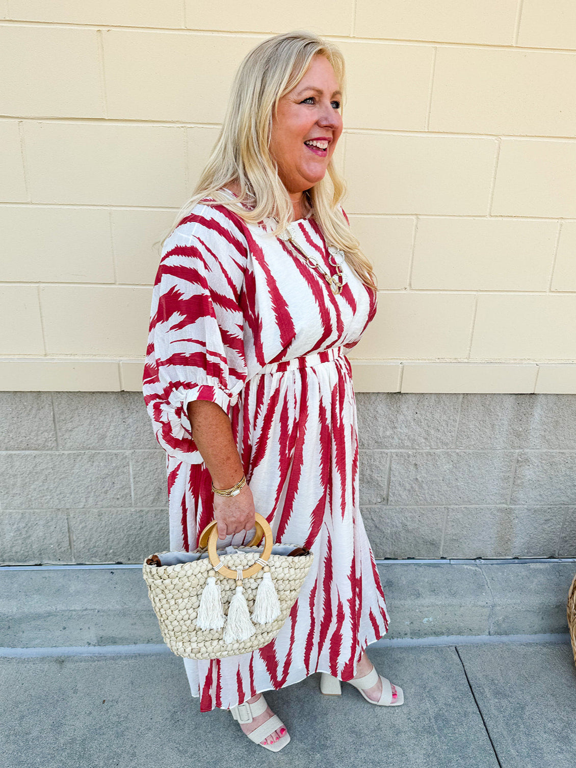 Model Crystal wearing the Red, White & Boom Dolman Sleeve Midi Dress featuring a bold zebra print, dolman sleeves, and a flattering elastic waist – styled for a confident, comfortable look perfect for day or night