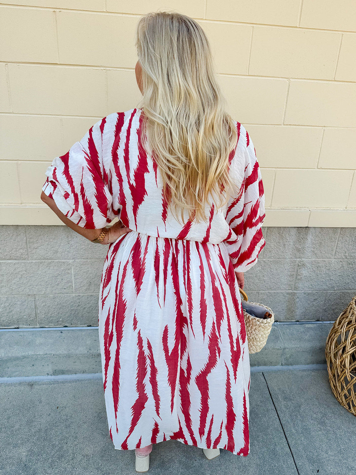 Model Crystal wearing the Red, White & Boom Dolman Sleeve Midi Dress featuring a bold zebra print, dolman sleeves, and a flattering elastic waist – styled for a confident, comfortable look perfect for day or night