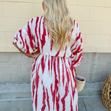 Model Crystal wearing the Red, White & Boom Dolman Sleeve Midi Dress featuring a bold zebra print, dolman sleeves, and a flattering elastic waist – styled for a confident, comfortable look perfect for day or night