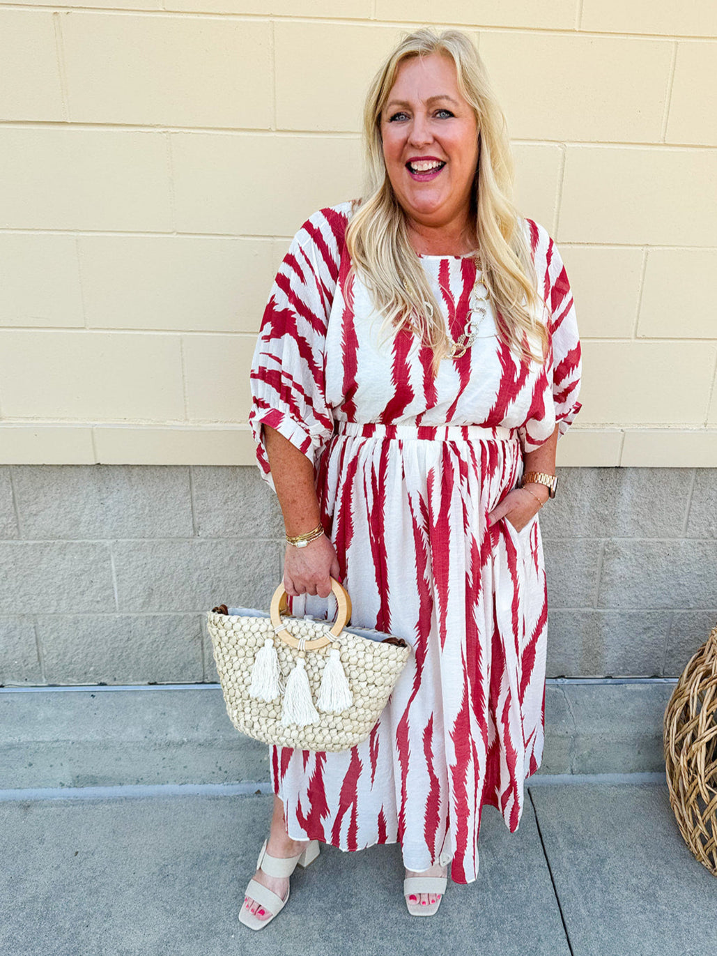 Model Crystal wearing the Red, White & Boom Dolman Sleeve Midi Dress featuring a bold zebra print, dolman sleeves, and a flattering elastic waist – styled for a confident, comfortable look perfect for day or night