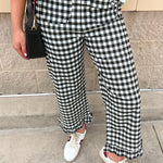 Black-and-white gingham high-rise pants with ruffled hems and front patch pockets
