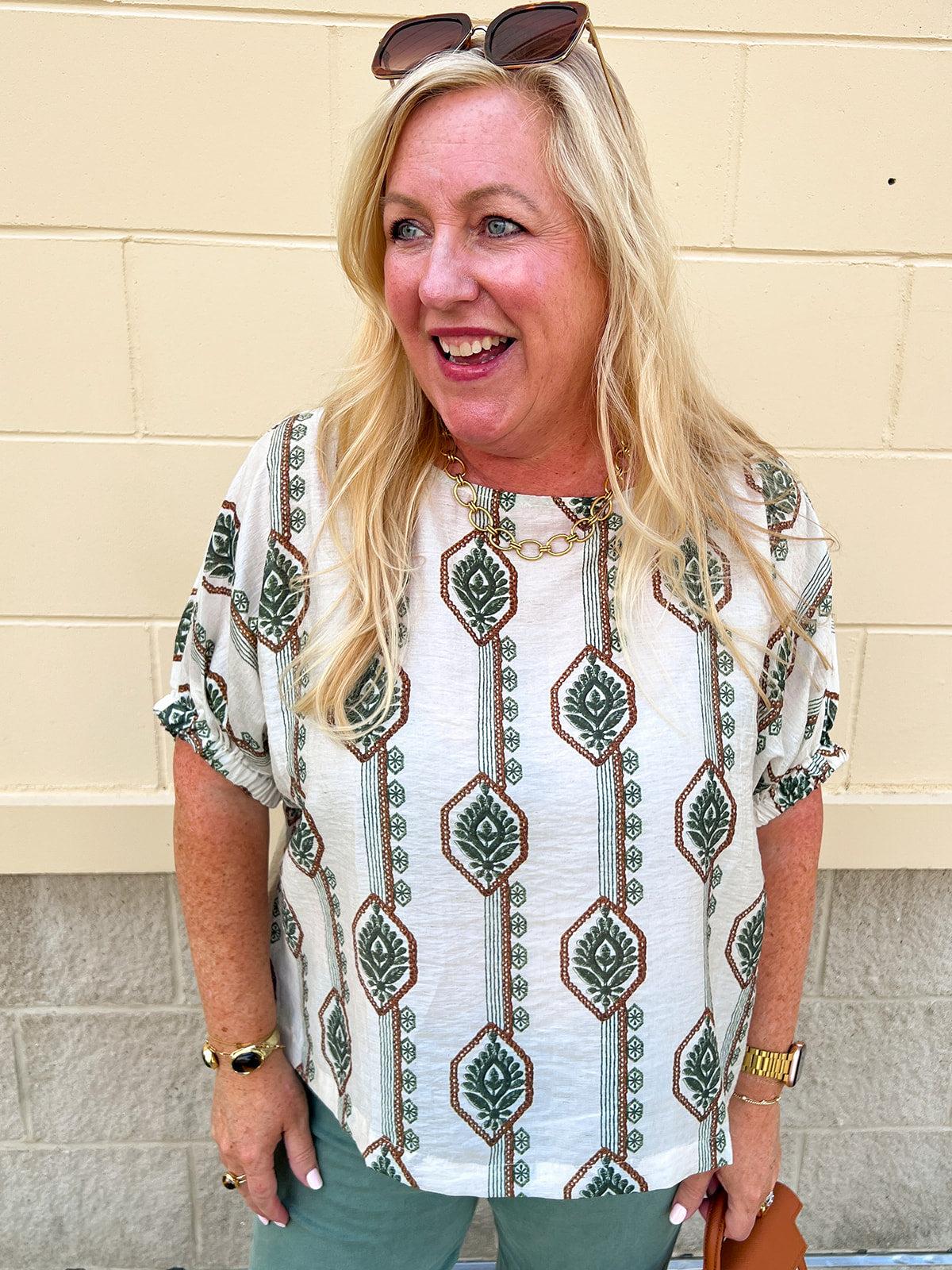 White linen blouse with green and brown boho-inspired pattern and elasticized sleeves