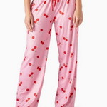 Pink pajama pants with red cherry print, wide-leg fit and elastic waistband.