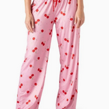 Pink pajama pants with red cherry print, wide-leg fit and elastic waistband.