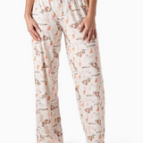 Cream pajama pants with cactus and cowgirl print, wide-leg fit, and elastic waistband with drawstring tie.