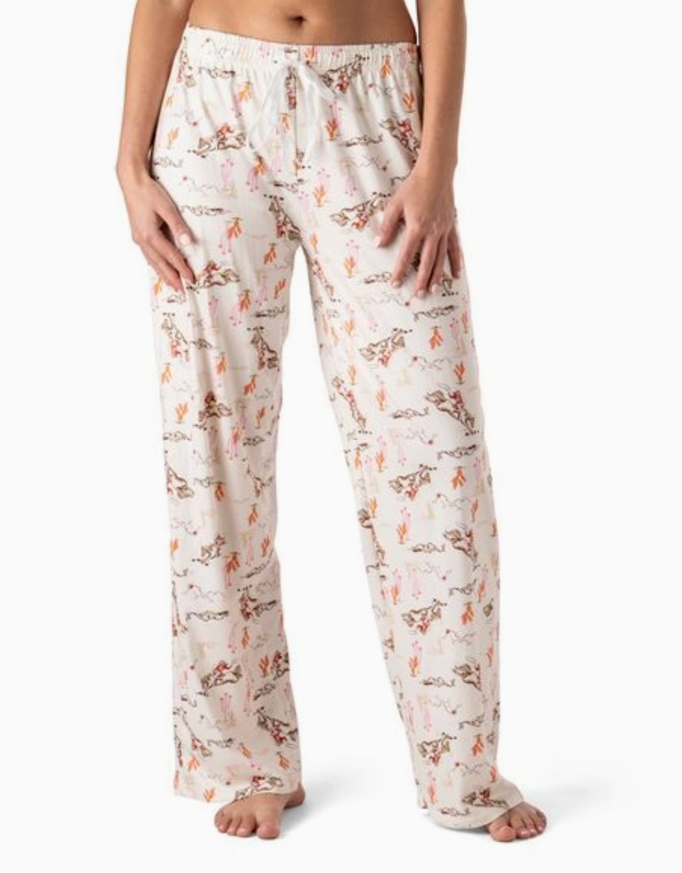 Cream pajama pants with cactus and cowgirl print, wide-leg fit, and elastic waistband with drawstring tie.