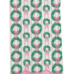 White Christmas tea towel with green wreaths, pink bows, pink stripes, and scalloped pink trim.