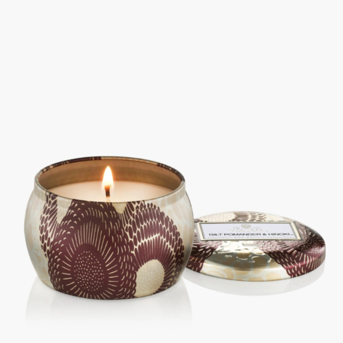 Mini tin candle in decorative Japonica-patterned vessel with lid.