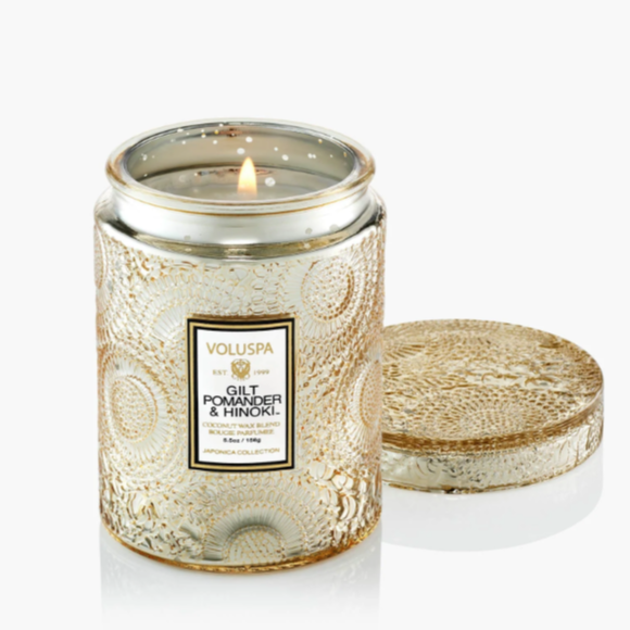 Small luxury candle in embossed glass jar with matching lid.