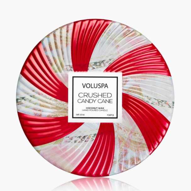 Holiday candle in festive candy cane patterned tin with three wicks and matching lid.