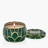 Mini holiday candle in decorative tin with embossed lid and festive metallic accents.