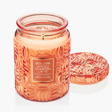 Large fall candle in embossed pumpkin-patterned glass jar with matching lid.