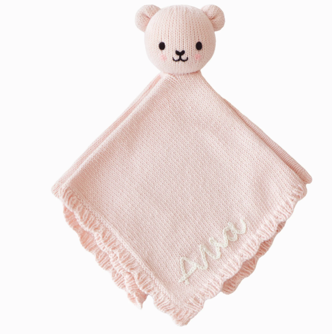 A blush hand-knit baby lovey with scalloped trim and embroidered details.