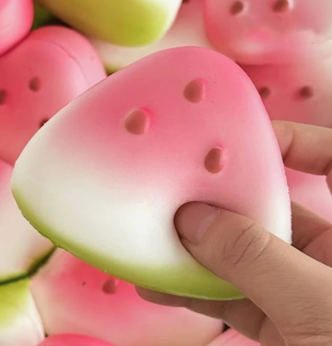 Watermelon slice slow-rising squishy toy with realistic watermelon details, vibrant red and green colors, and a soft foam texture.