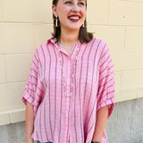 Oversized pink striped cotton gauze blouse with collar, button-down front, drop shoulders, and half sleeves.