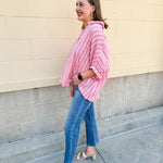 Oversized pink striped cotton gauze blouse with collar, button-down front, drop shoulders, and half sleeves.