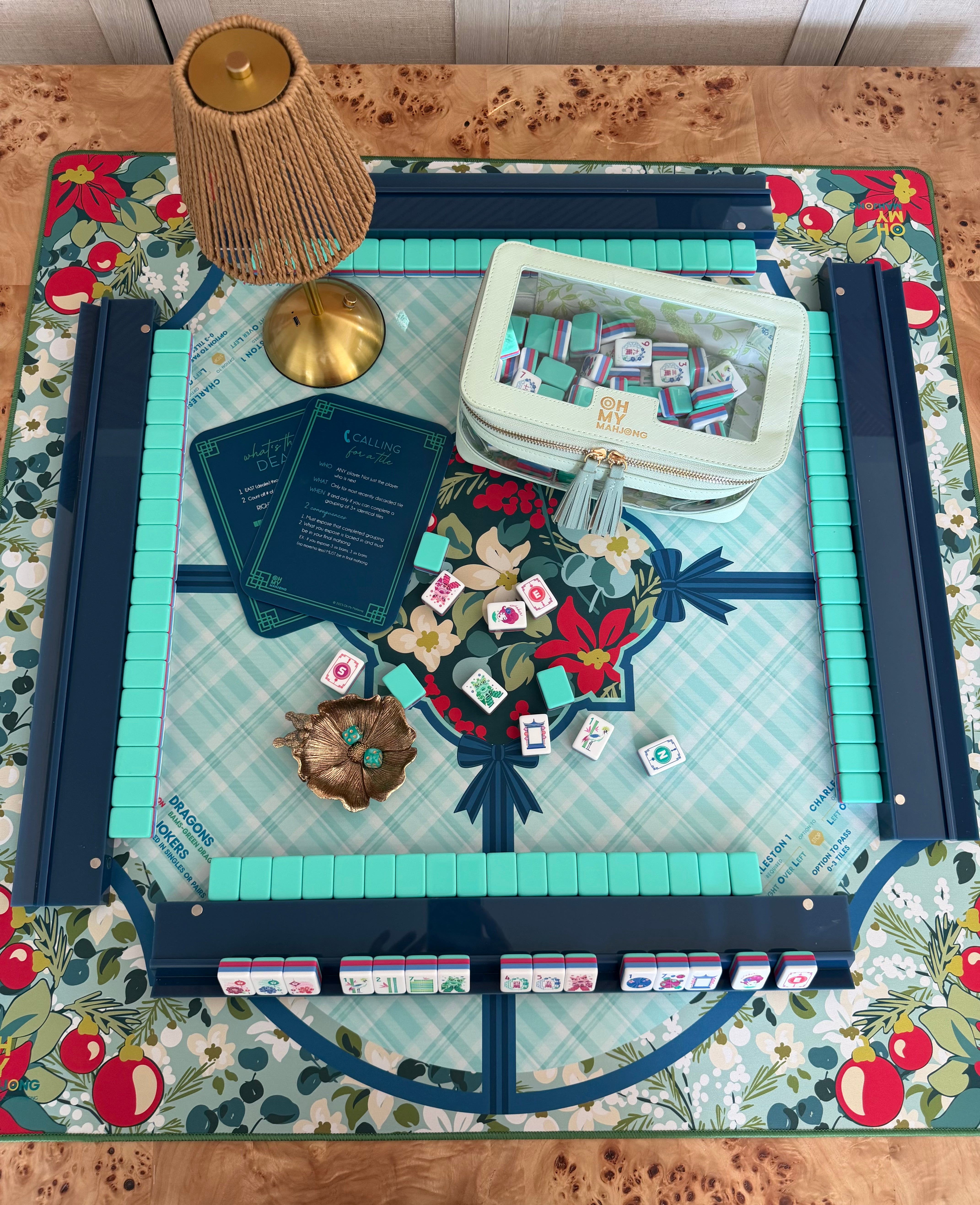 Seabreeze x Winterberry Luxury Mahjong Tablescape with Seabreeze tiles, Winterberry mat, Laurel lamp, The Mahjong House navy racks, mint tile storage bag, blue shufflers, Mint Duchess dice, and Magnolia Perch dice dish.