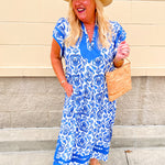 Blue and white printed midi dress with contrast neckline and flutter sleeves