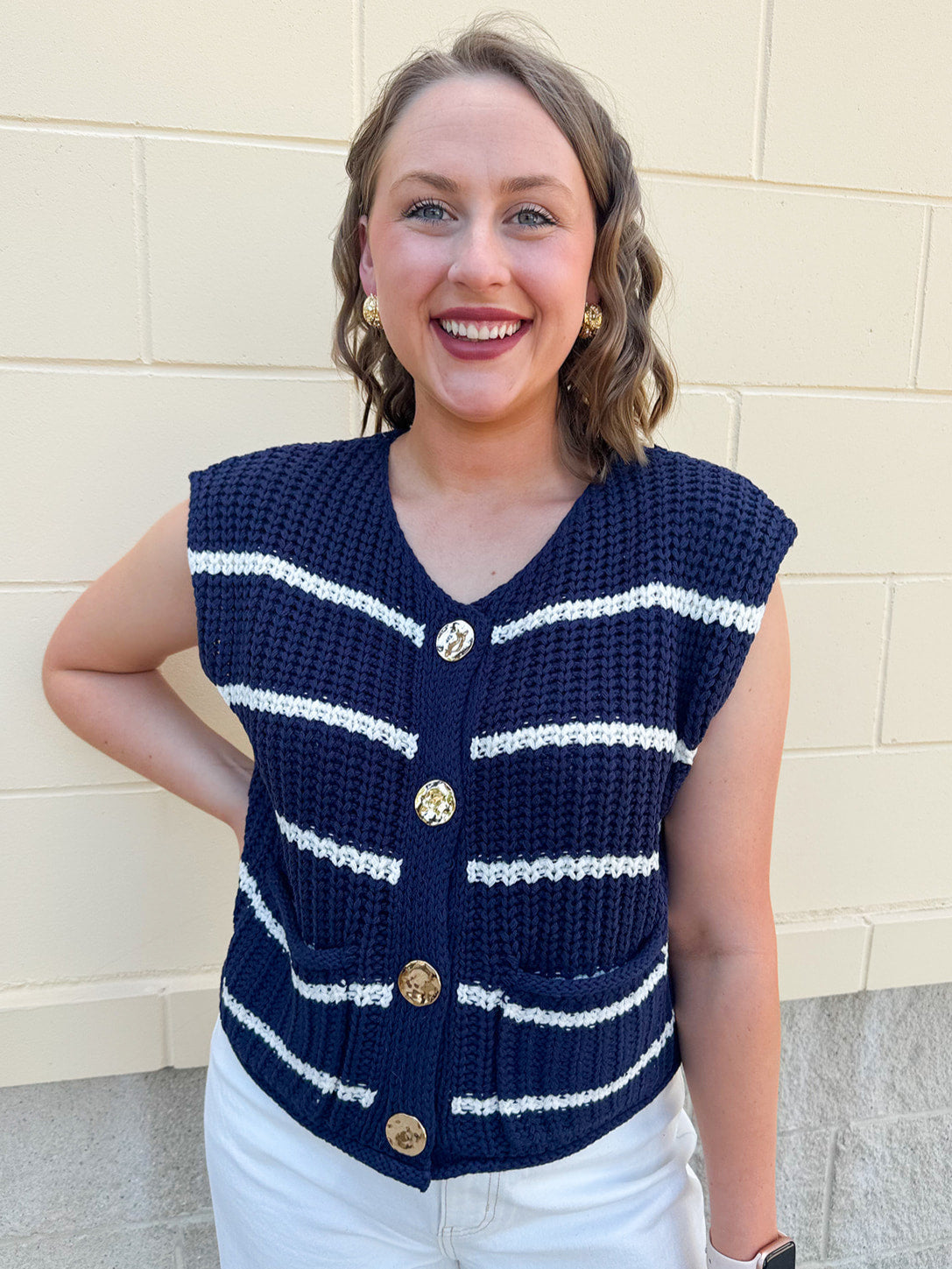 Navy and white striped crochet vest with front pockets, buttons, and sleeveless relaxed fit.