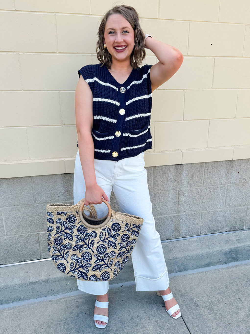 Navy and white striped crochet vest with front pockets, buttons, and sleeveless relaxed fit.
