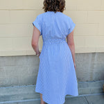 Model wearing the Skyline Views Striped Midi Dress with a classic striped pattern, cuffed short sleeves, and an elastic waistline – styled for a breezy, sun-soaked summer day by the coast or in the city