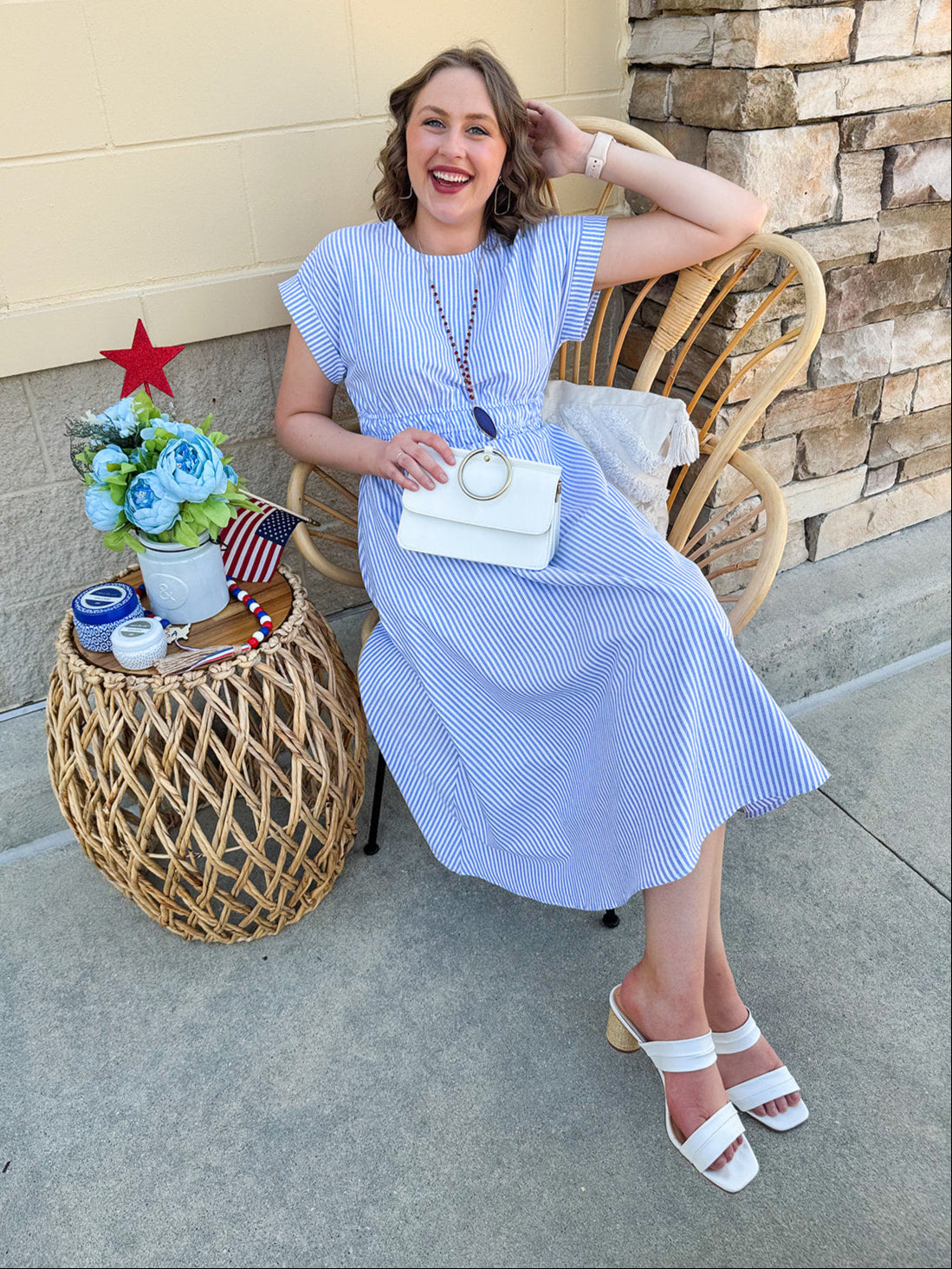Model wearing the Skyline Views Striped Midi Dress with a classic striped pattern, cuffed short sleeves, and an elastic waistline – styled for a breezy, sun-soaked summer day by the coast or in the city