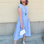 Model wearing the Skyline Views Striped Midi Dress with a classic striped pattern, cuffed short sleeves, and an elastic waistline – styled for a breezy, sun-soaked summer day by the coast or in the city