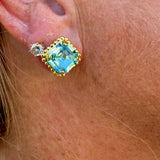 Bright gold-tone stud earrings with aquamarine square-cut crystals and a metal beaded halo from Sorrelli’s Aquamarine Collection.