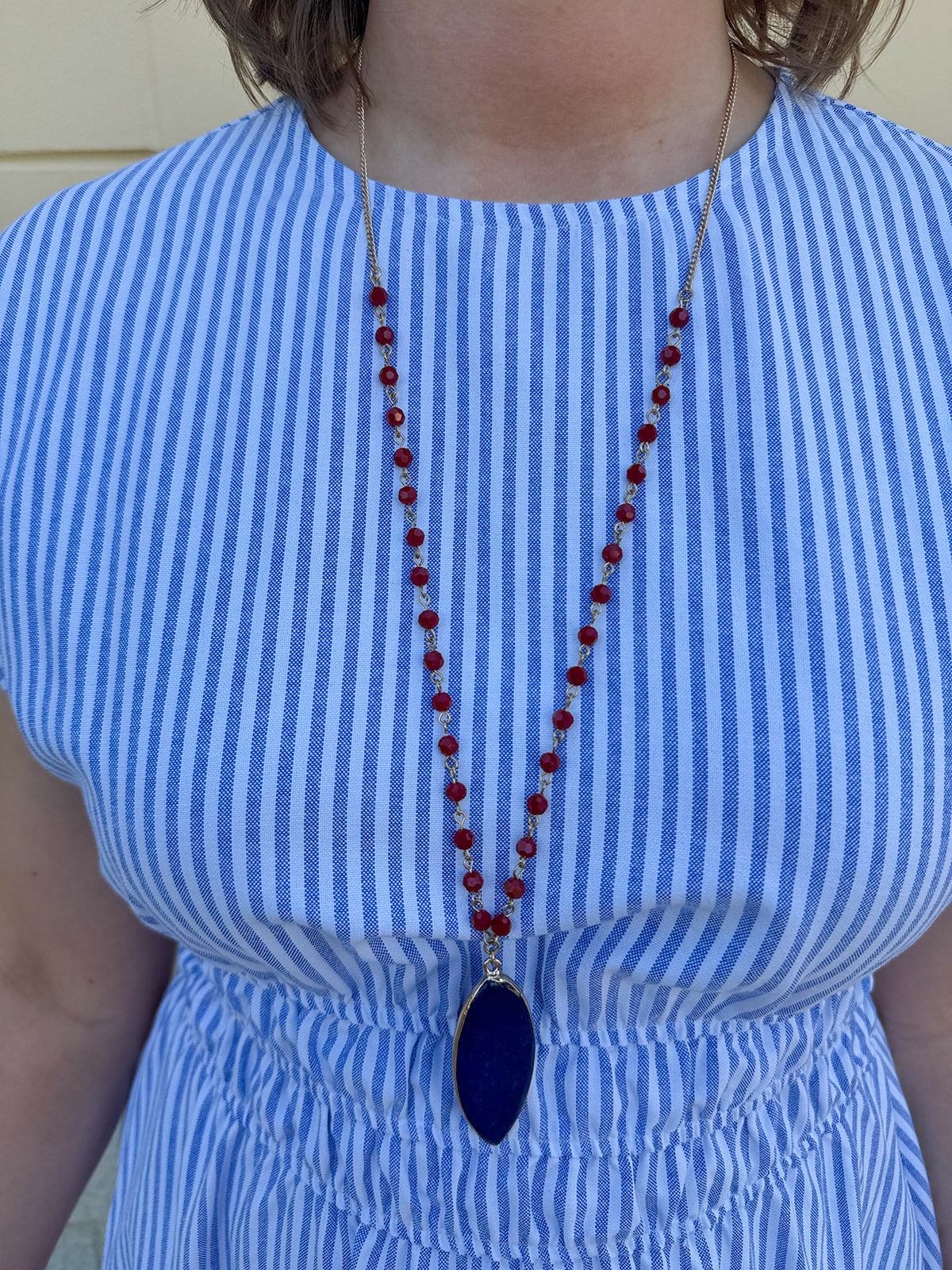 Stargazer Sapphire Beaded Stone Pendant Necklace with navy pendant and red beads on a delicate chain.