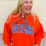 Women's orange fleece crewneck sweatshirt featuring oversized Florida collegiate graphics with vintage chenille detailing and a relaxed fit.
