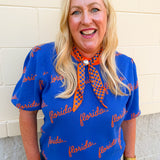 Women's blue puff sleeve knit sweater featuring scattered orange cursive florida lettering and a classic crew neckline.