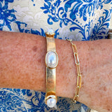 Gold stretch bracelet with oval pearl accents, designed for a classic and comfortable fit that complements any outfit