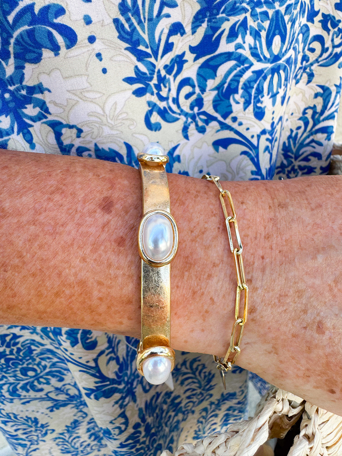 Gold stretch bracelet with oval pearl accents, designed for a classic and comfortable fit that complements any outfit