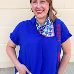 Royal blue flowy woven top with collared neckline, drop shoulder short sleeves, and subtle V-neck detail.