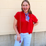 Red flowy woven top with collared neckline, drop shoulder short sleeves, and subtle V-neck detail.
