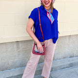 Royal blue flowy woven top with collared neckline, drop shoulder short sleeves, and subtle V-neck detail.