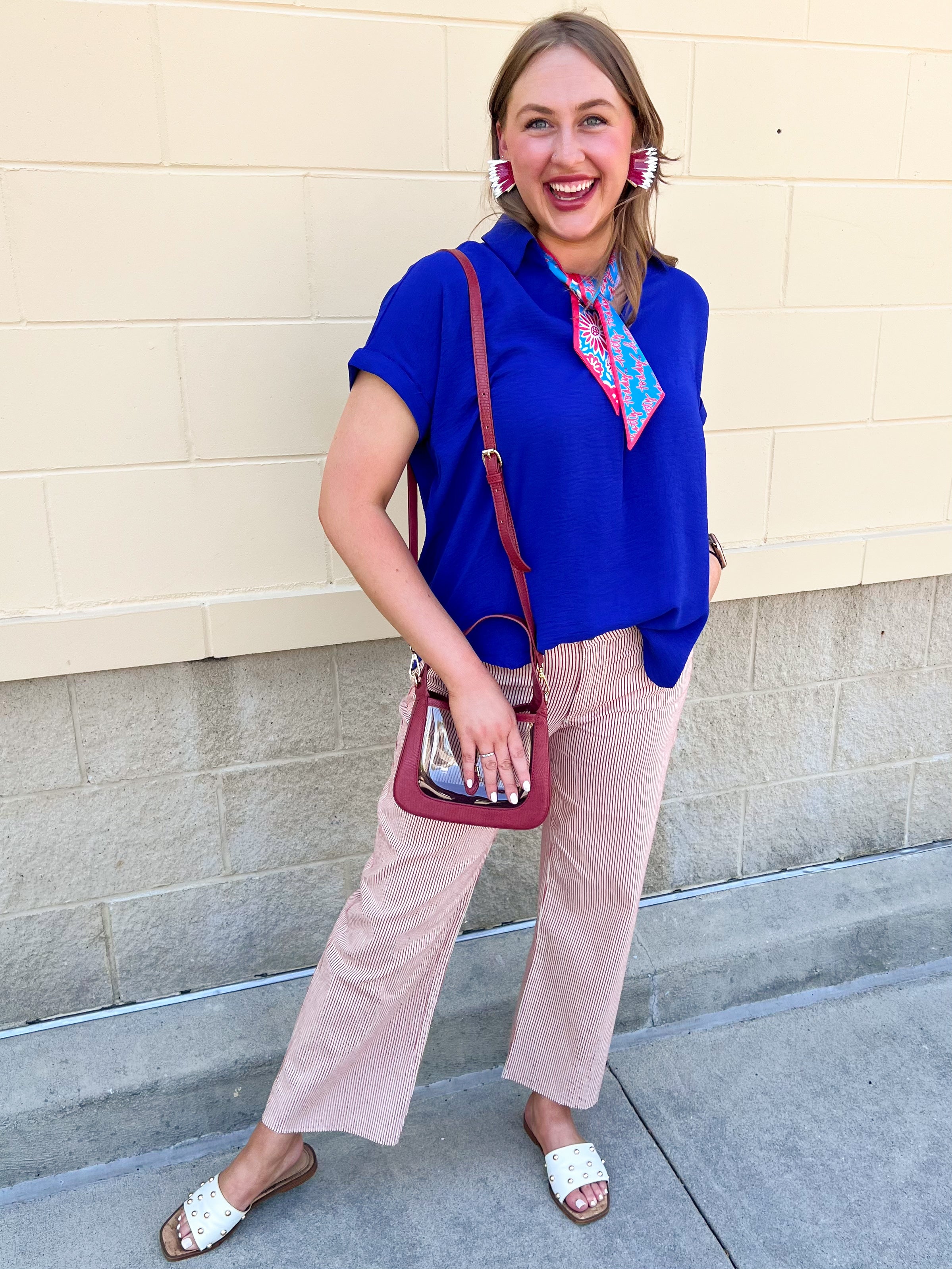 Royal blue flowy woven top with collared neckline, drop shoulder short sleeves, and subtle V-neck detail.