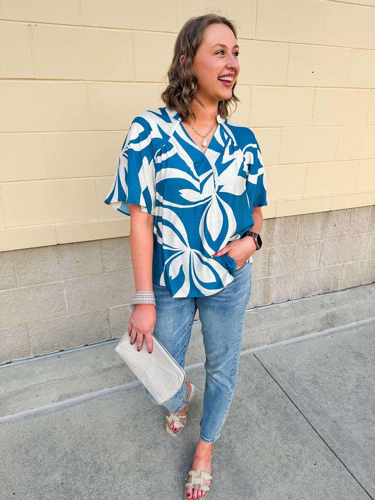 Lightweight linen blend top with a blue and white tropical print, featuring a V-neckline and relaxed fit for an easy, breezy warm-weather look