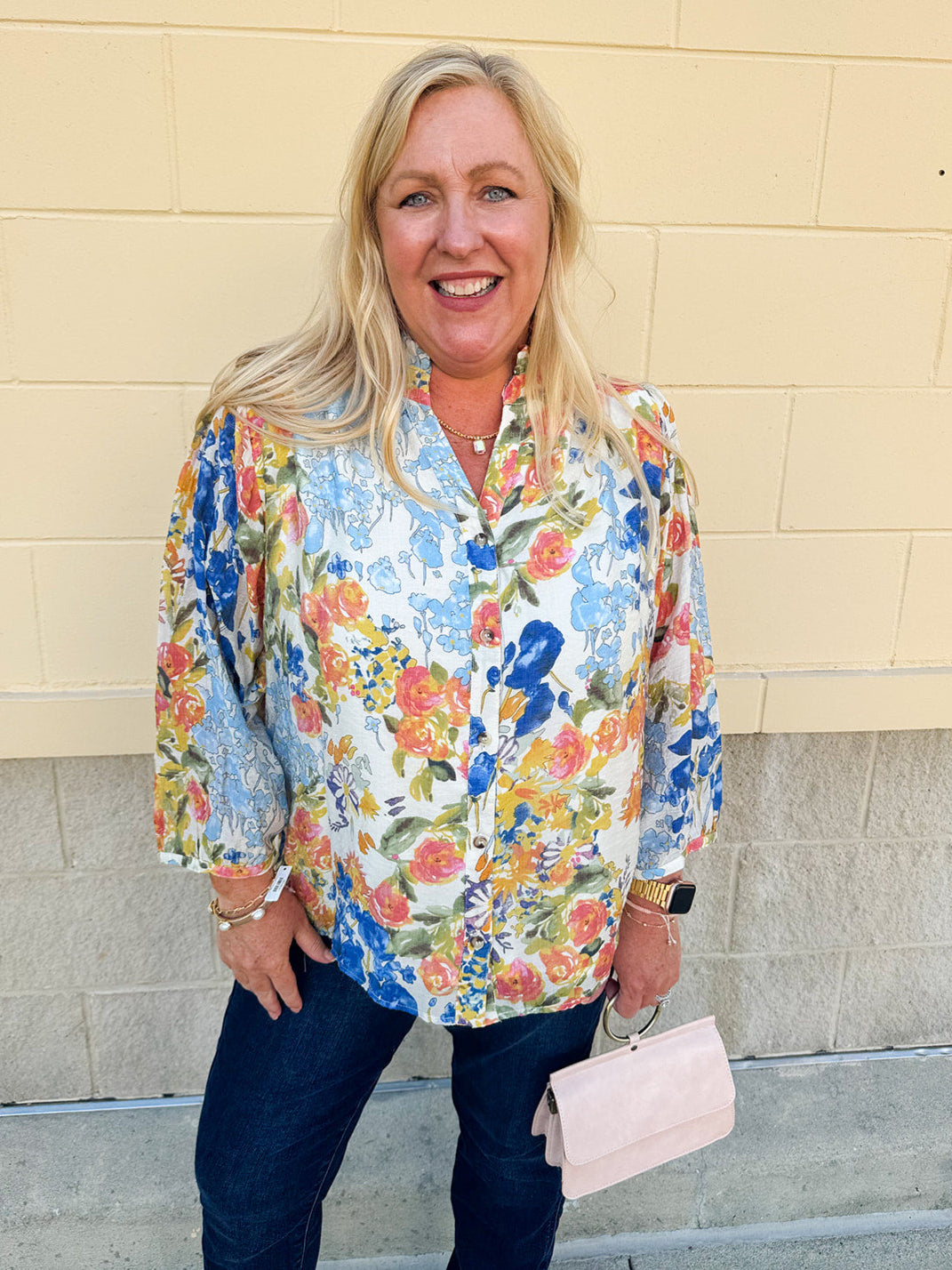 Floral chiffon blouse with frilled neckline, button front, dolman sleeves, and lightweight, flowy fit.
