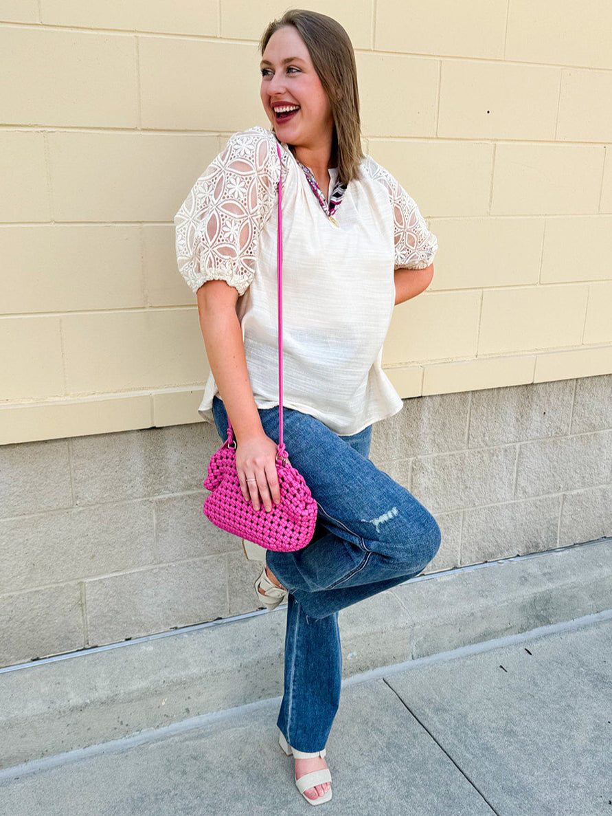 Cream-colored split neck top with lace sleeves, styled for lightweight comfort and feminine charm.