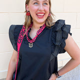 Black woven top with split neckline, short ruffle sleeves, and stitch detailing.